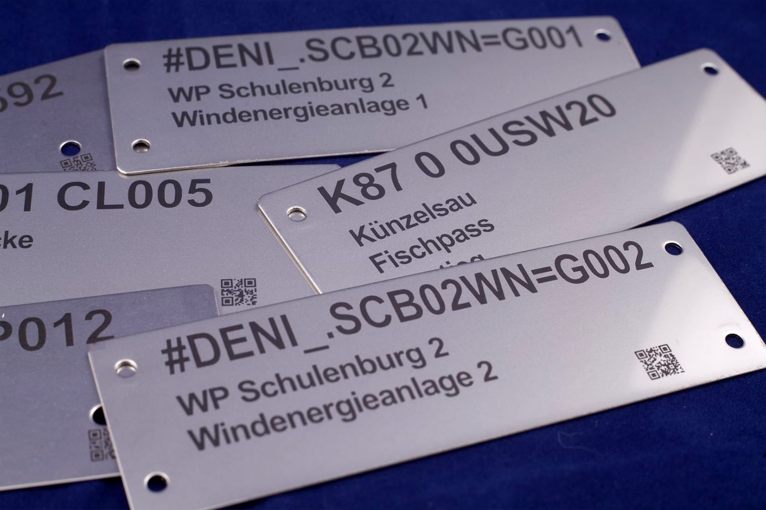 several pieces of stainless steel identification plates with laser engraving
