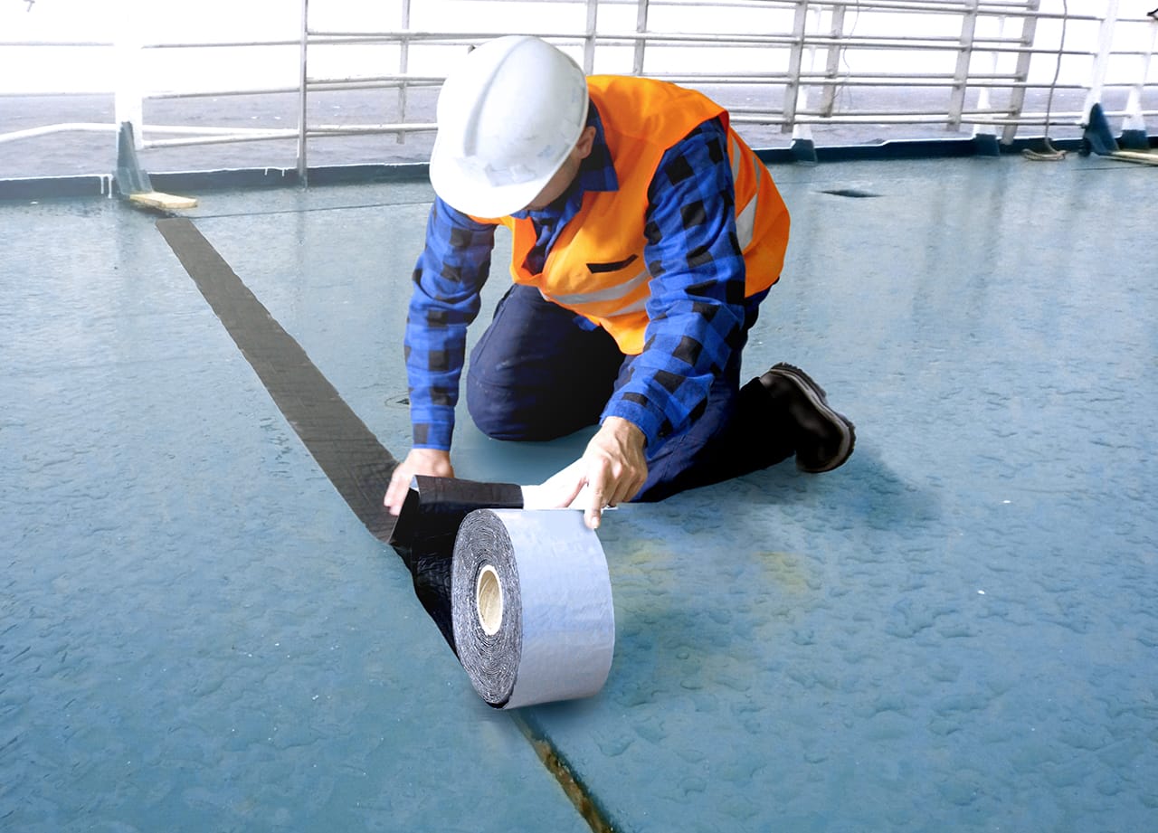 man on ship deck use black cover tape