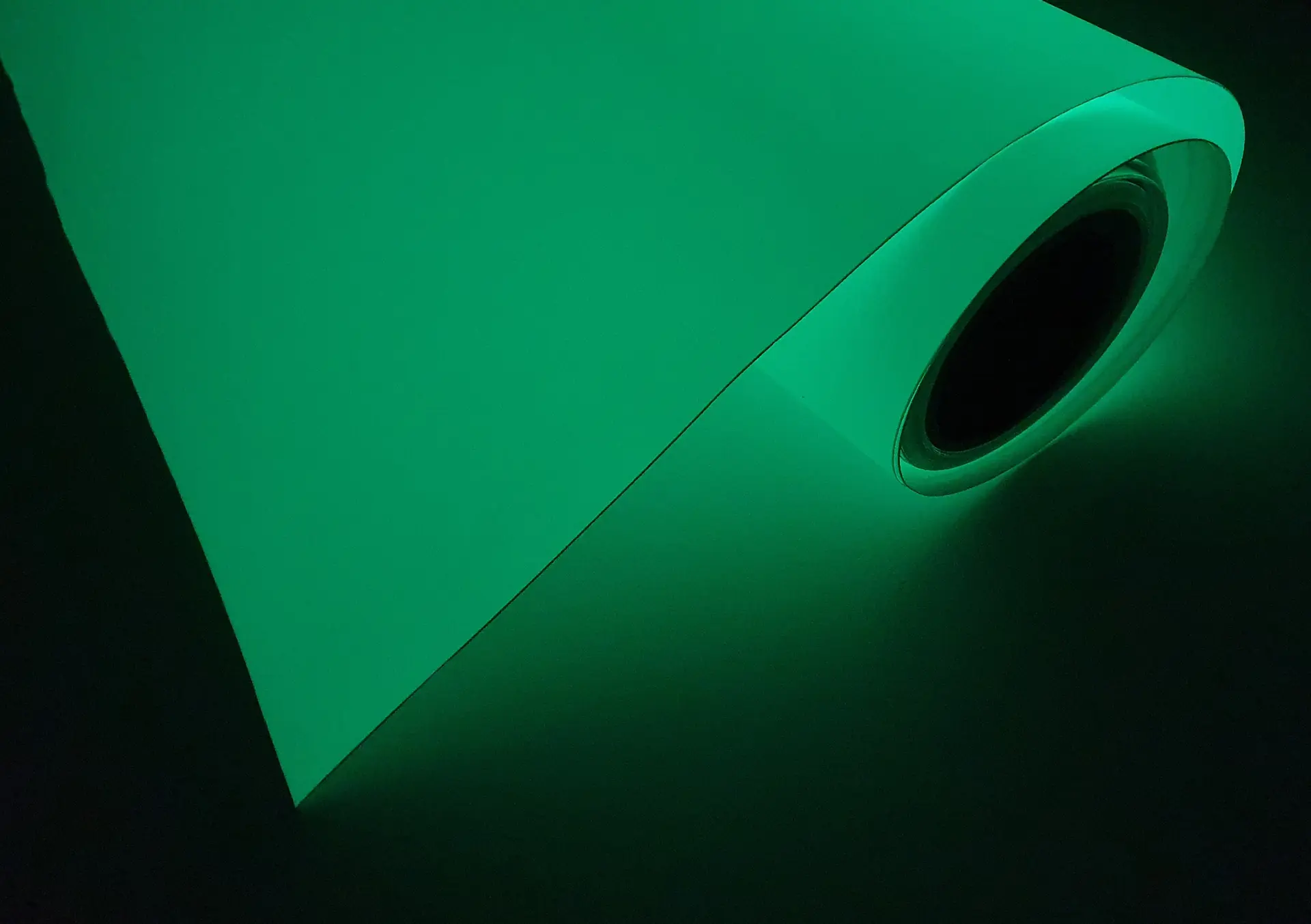 photoluminescent foil roll glowing green in dark